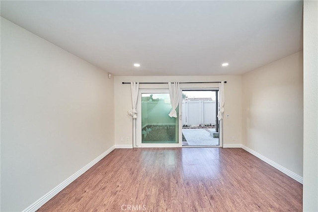 spare room with hardwood / wood-style floors