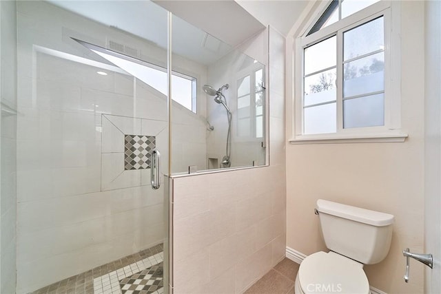 bathroom featuring an enclosed shower and toilet