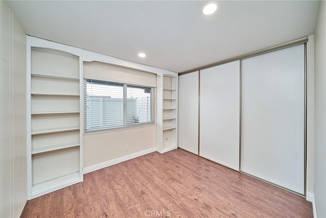 unfurnished bedroom with light wood-type flooring