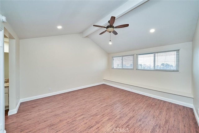 unfurnished room with hardwood / wood-style flooring, lofted ceiling with beams, and ceiling fan