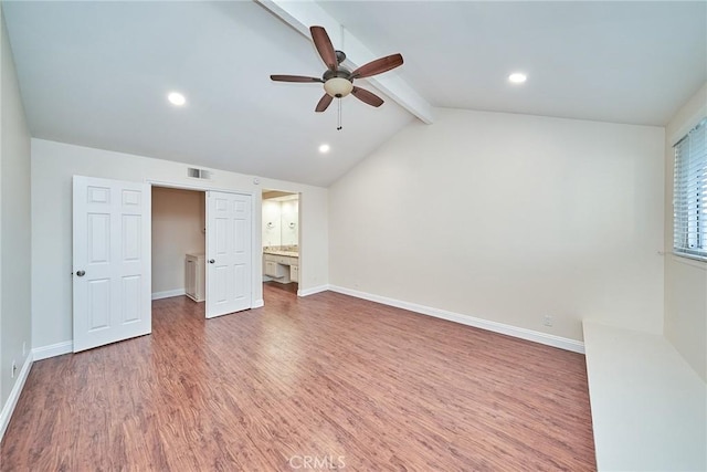 unfurnished bedroom featuring dark wood-type flooring, lofted ceiling with beams, ceiling fan, and ensuite bathroom