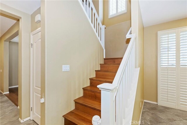 staircase featuring tile patterned flooring