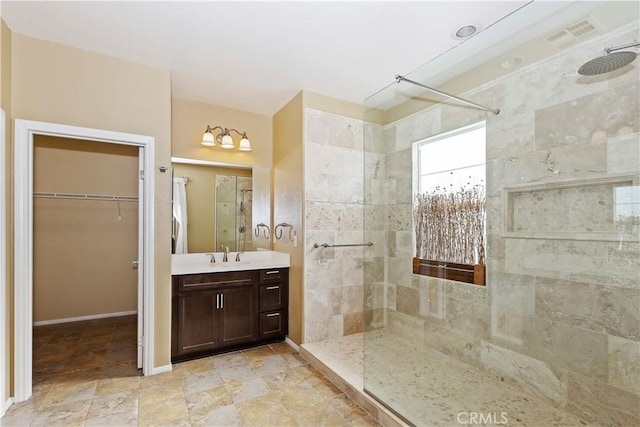 bathroom featuring vanity and a tile shower