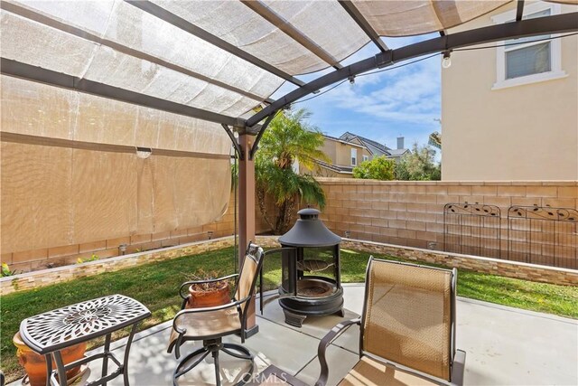 view of patio / terrace with a fire pit and a pergola