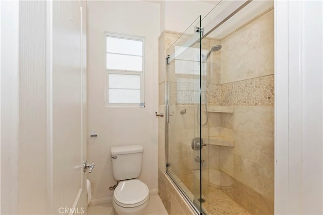 bathroom with an enclosed shower and toilet