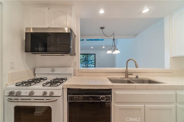 kitchen with sink, tile countertops, white cabinets, and black appliances