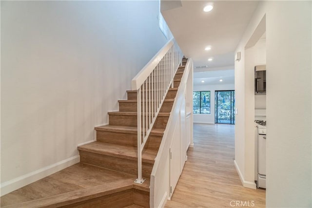 staircase featuring wood-type flooring