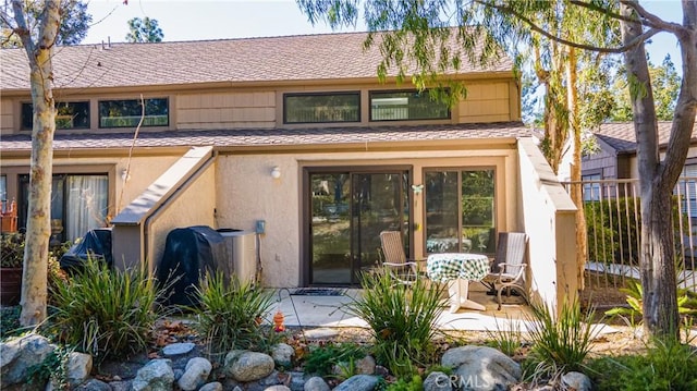 back of house with a patio