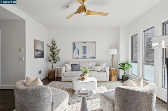 living room with dark wood-type flooring and ceiling fan