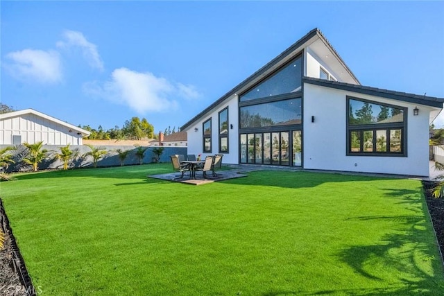 back of property featuring a patio area and a lawn