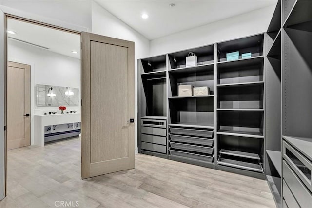 walk in closet with vaulted ceiling