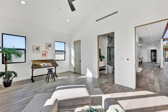 living room featuring hardwood / wood-style flooring and high vaulted ceiling