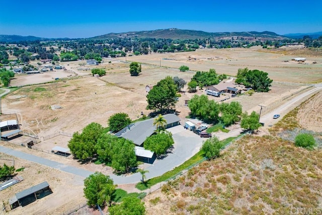 birds eye view of property featuring a mountain view and a rural view