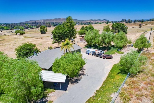 drone / aerial view featuring a mountain view and a rural view