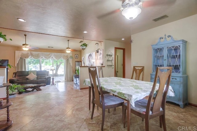 tiled dining space featuring ceiling fan