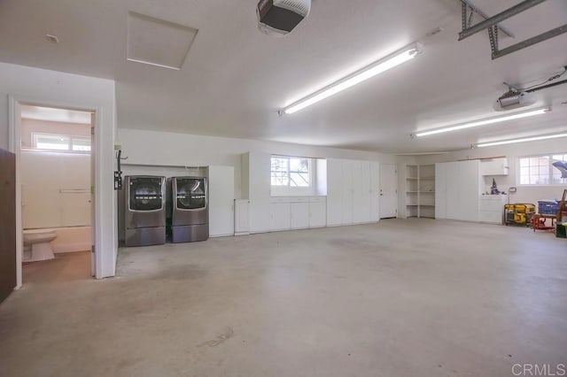 garage featuring a garage door opener and washer and dryer