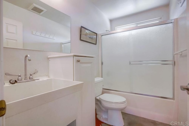 full bathroom featuring sink, shower / bath combination with glass door, and toilet