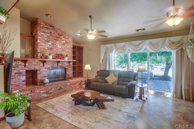 tiled living room featuring lofted ceiling, a brick fireplace, and ceiling fan