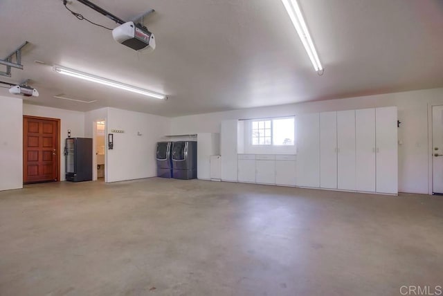 garage with black fridge, a garage door opener, and refrigerator