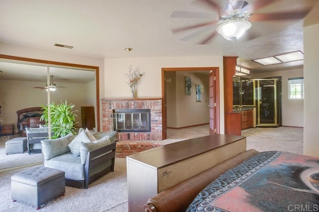 interior space with a closet, ceiling fan, light colored carpet, and a brick fireplace