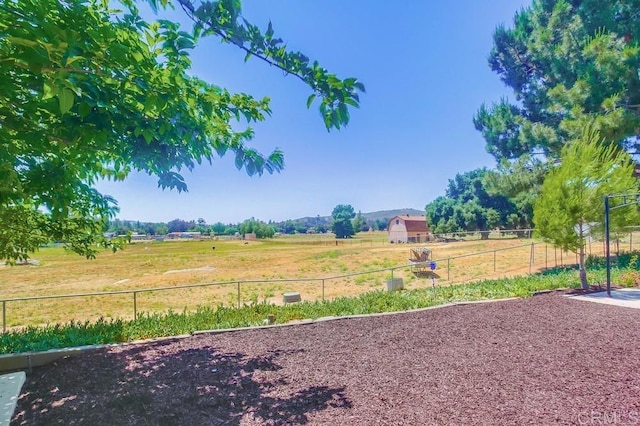 view of yard with a rural view