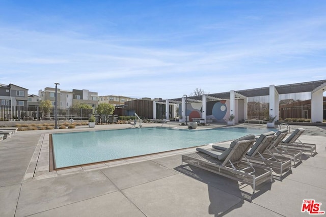 view of pool featuring a hot tub and a patio area