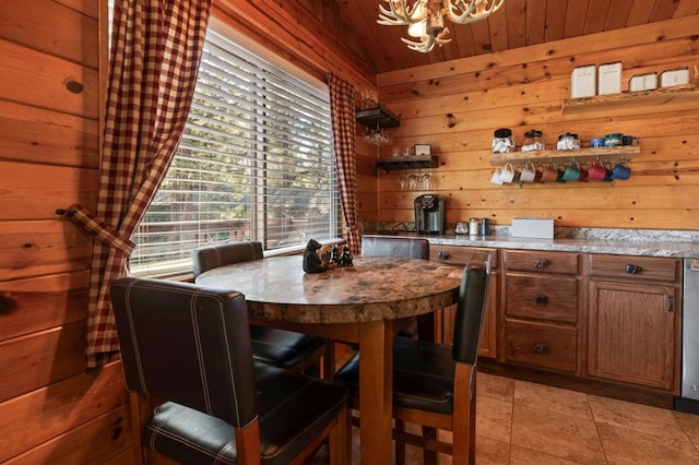 dining room featuring light tile patterned flooring, wooden walls, vaulted ceiling, and wooden ceiling