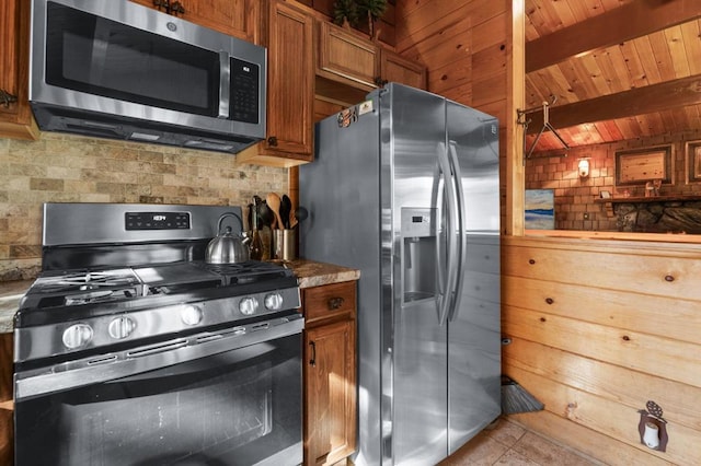 kitchen featuring beamed ceiling, backsplash, light tile patterned floors, wood ceiling, and stainless steel appliances