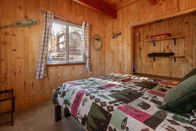 bedroom with beamed ceiling, carpet, and wood walls