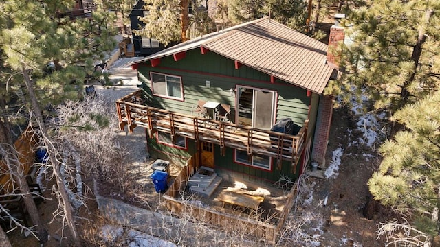 rear view of property featuring a wooden deck