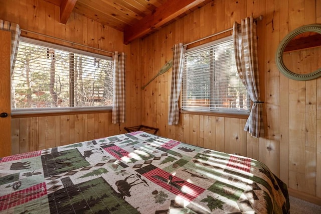 unfurnished bedroom featuring beam ceiling, wooden walls, wooden ceiling, and carpet flooring