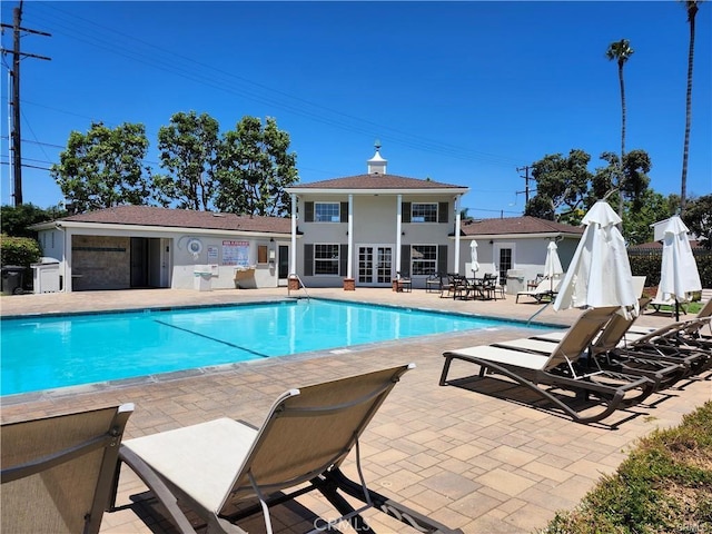 view of pool with an outbuilding and a patio area