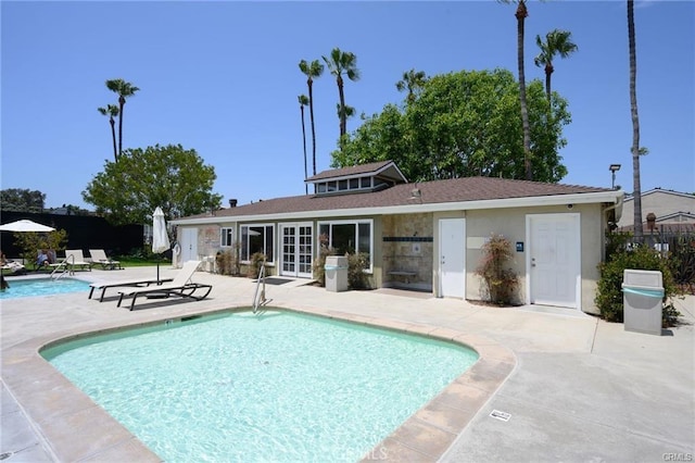 view of pool featuring a patio and french doors