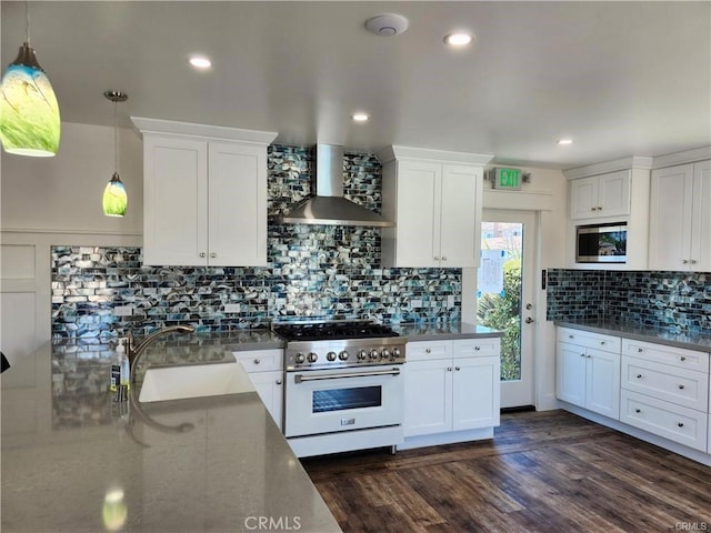 kitchen with white cabinetry, high end stove, and wall chimney range hood