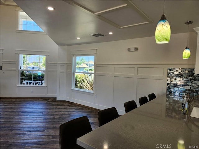 unfurnished dining area with vaulted ceiling and dark hardwood / wood-style flooring