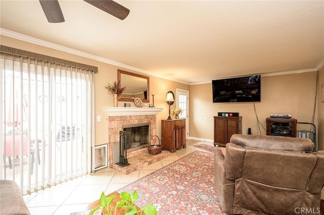 tiled living room featuring ceiling fan, ornamental molding, and a tile fireplace