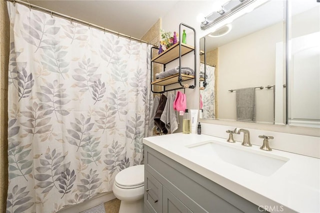 bathroom featuring vanity, toilet, and a shower with shower curtain