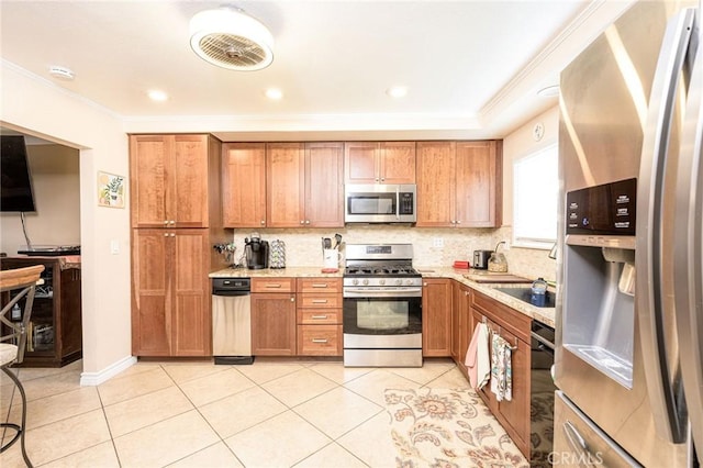 kitchen with light tile patterned floors, ornamental molding, stainless steel appliances, light stone countertops, and backsplash