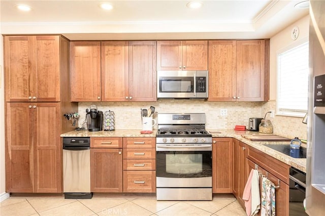 kitchen featuring appliances with stainless steel finishes, light tile patterned floors, and decorative backsplash