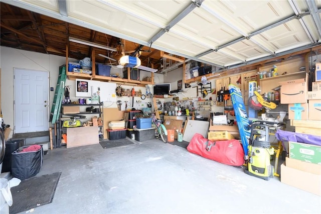 garage with a garage door opener and a workshop area