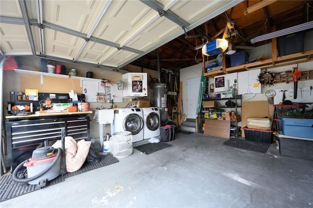 garage with independent washer and dryer, water heater, a garage door opener, and a workshop area