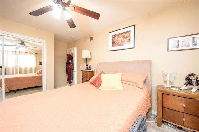 bedroom with light colored carpet, ceiling fan, and a closet