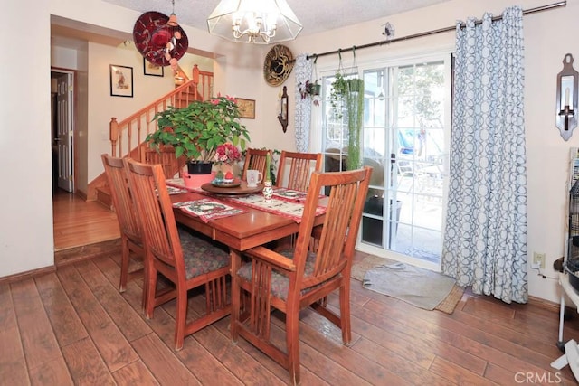 dining room featuring dark hardwood / wood-style flooring and a chandelier