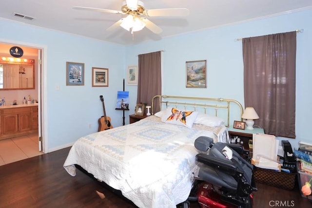 bedroom featuring hardwood / wood-style floors, crown molding, ceiling fan, and ensuite bathroom