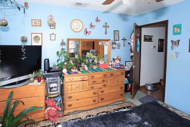 interior space featuring ceiling fan and a textured ceiling