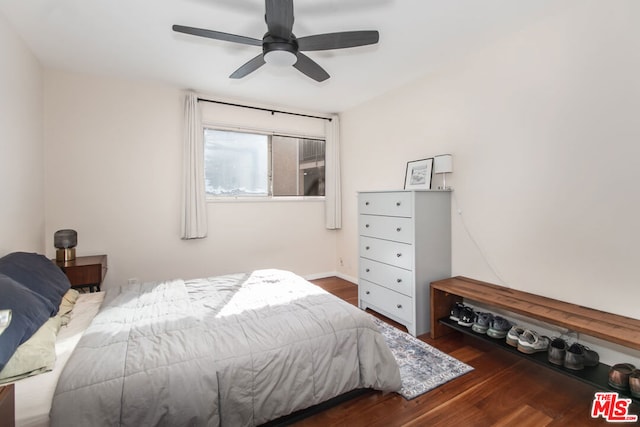 bedroom with dark hardwood / wood-style floors and ceiling fan