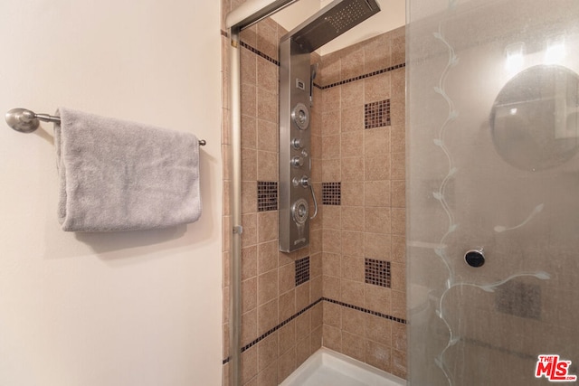 bathroom with tiled shower