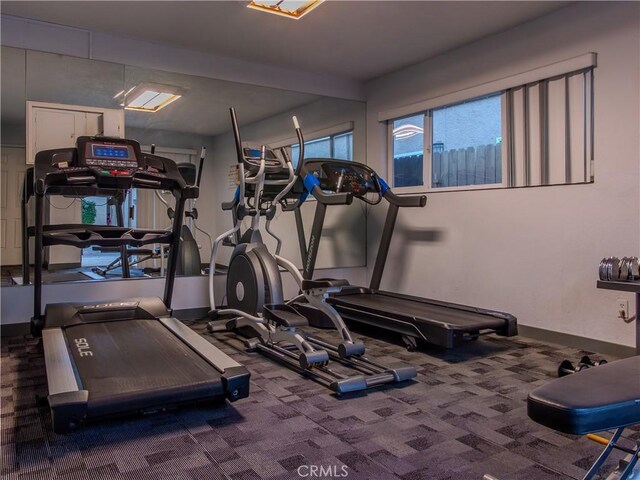 workout area featuring dark colored carpet