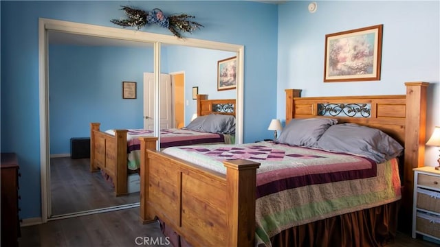 bedroom with dark hardwood / wood-style floors