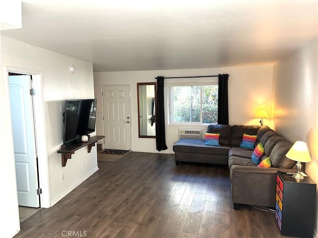 living room with dark hardwood / wood-style flooring and a wall unit AC